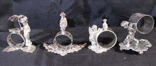 334a - 4 Victorian silver-plate napkin rings of people