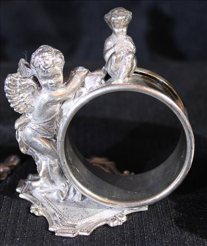 334c - 4 Victorian silver-plate napkin rings of people