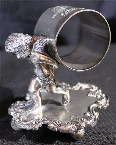 334d - 4 Victorian silver-plate napkin rings of people