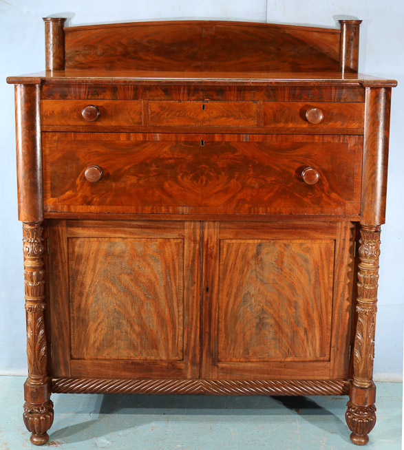 060a - Flame mahogany Empire Jackson press with acanthus carved column front and backsplash, 61.5 in. T, 51 in. W, 23.5 in. D.