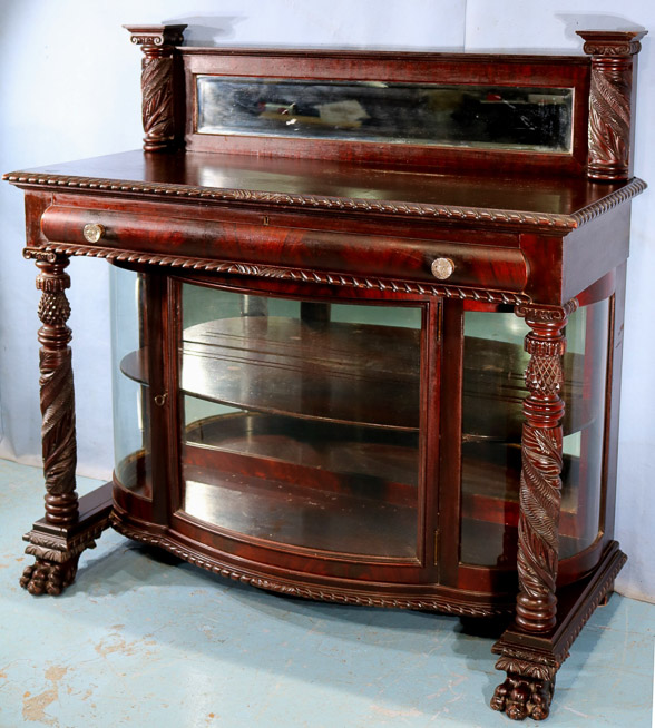 065b - Flame mahogany dessert cabinet with mirrored backsplash, acanthus carved column front and claw feet, 47.5 in. T, 48 in. W, 20 in. D.