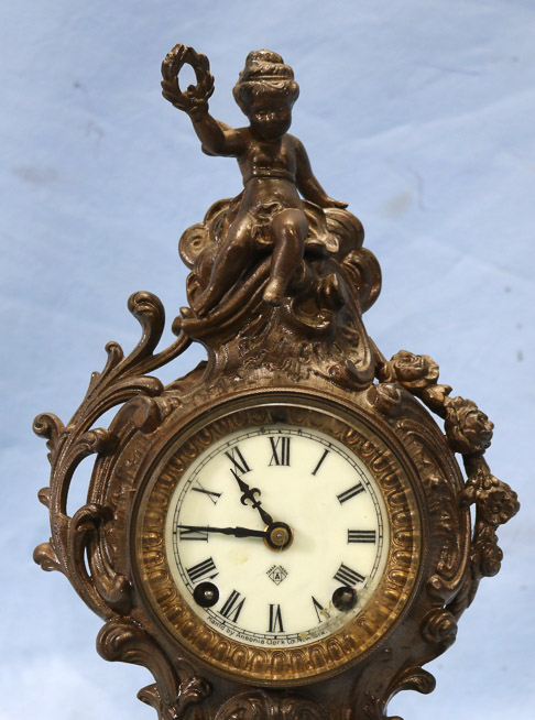 164b - Metal figural ansonia clock, runs, 12 in. T.-9