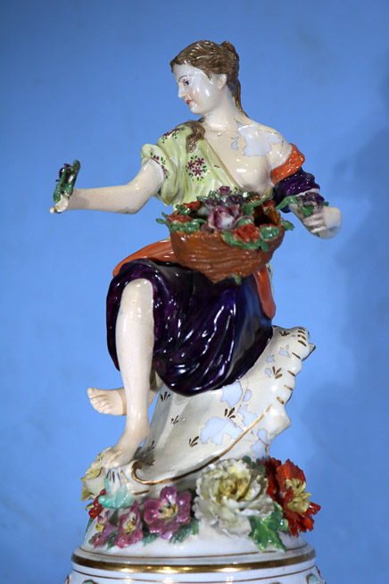 034d - Palace size Dresden capped urn decorated with flowers and large cupids, has painting of royal court and full body figure on top of lid, 36 in. T, 16 in. W.-25