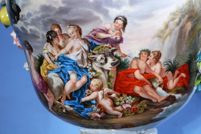 034f - Palace size Dresden capped urn decorated with flowers and large cupids, has painting of royal court and full body figure on top of lid, 36 in. T, 16 in. W.-25