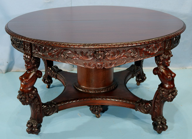 066u - 11 piece Mahogany R.J. Horner dining room suit with cupids, ca. 1890, table, 30.5 in. T, 55 in. Dia., has 5 12 in. leaves-28