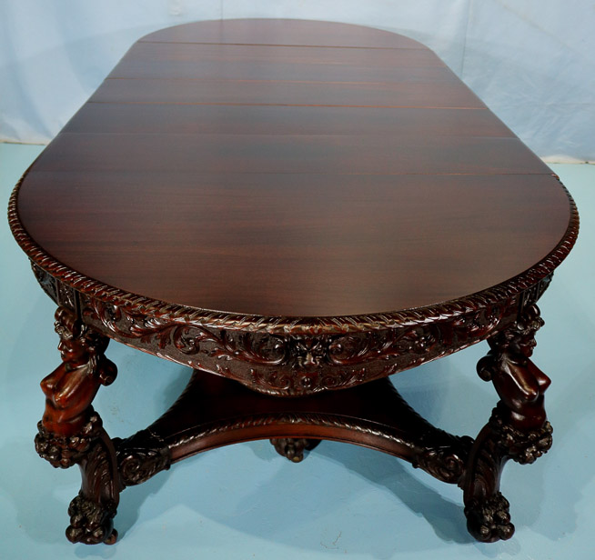 066y - 11 piece Mahogany R.J. Horner dining room suit with cupids, ca. 1890, table, 30.5 in. T, 55 in. Dia., has 5 12 in. leaves-28