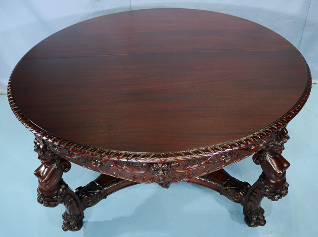 066z - 11 piece Mahogany R.J. Horner dining room suit with cupids, ca. 1890, table, 30.5 in. T, 55 in. Dia., has 5 12 in. leaves-28