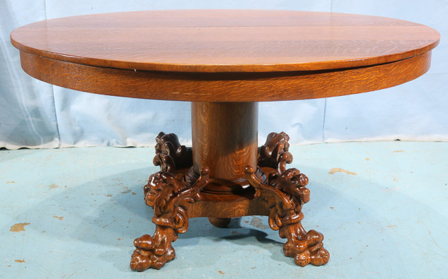 100a - Solid oak dining table with winged griffin and large claw feet on base, 4 leaves, 8.5 in. W.-28