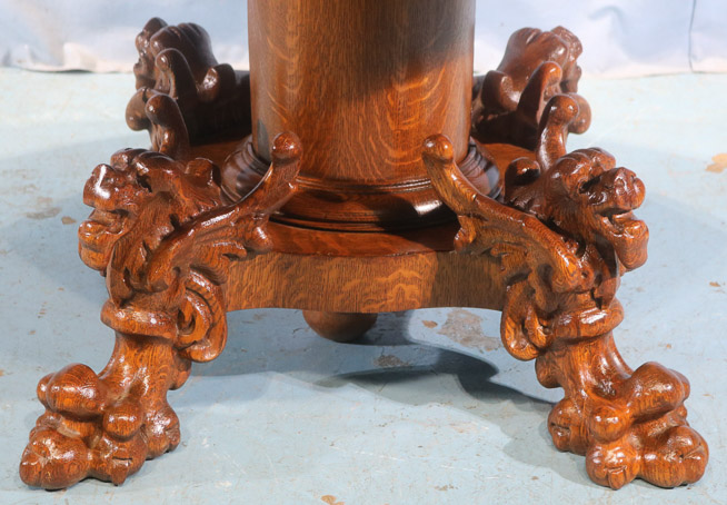 100b - Solid oak dining table with winged griffin and large claw feet on base, 4 leaves, 8.5 in. W.-28