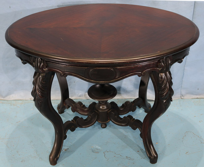 105b - Rosewood Victorian parlor table with cup finial, book match veneer top and carved stretcher, 29 in. T, 40 in. W, 28.5 in. D.-28