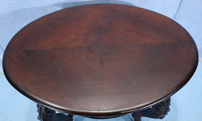 105c - Rosewood Victorian parlor table with cup finial, book match veneer top and carved stretcher, 29 in. T, 40 in. W, 28.5 in. D.-28