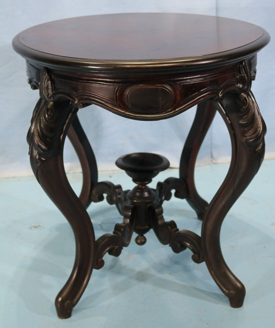 105f - Rosewood Victorian parlor table with cup finial, book match veneer top and carved stretcher, 29 in. T, 40 in. W, 28.5 in. D.-28