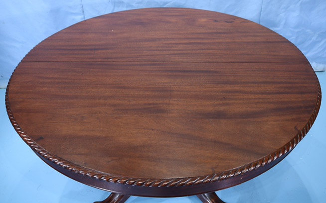 115c - Mahogany Empire banquet table with acanthus carved base and ball and claw feet, 31 in. T, 9 ft. 8 in. W, 54 in. Dia.-28