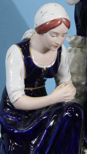 018c - Porcelain figure of a shepherd and his wife kneeling by Royal Dux, 18 in. T, 10 in. W, 7 in. D.