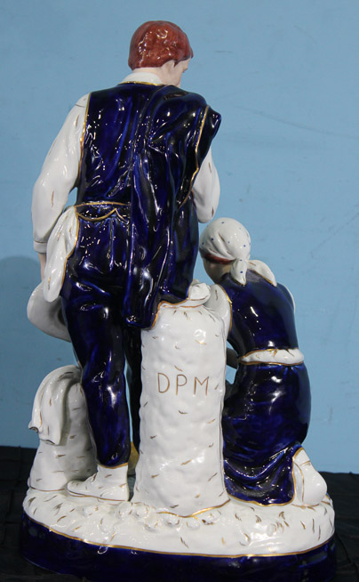 018g - Porcelain figure of a shepherd and his wife kneeling by Royal Dux, 18 in. T, 10 in. W, 7 in. D.