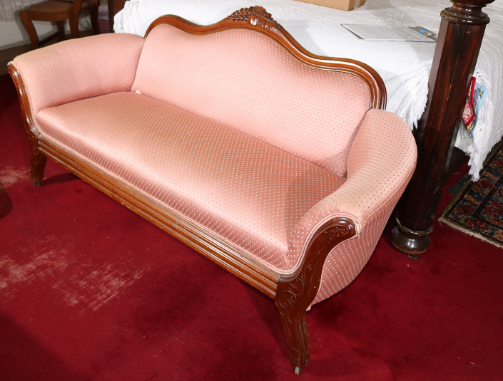 029b - Walnut Victorian loveseat with grape crest and pink upholstery, 31 in. T, 63 in. L, 16 in D.