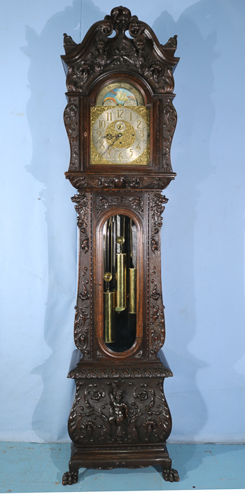 084a - Oak heavily carved 5 tube grandfather clock by R.J. Horner with Tiffany works, has carved figures and claw feet, 8 ft. 10 in. T, 27 in. W, 27 in. D.