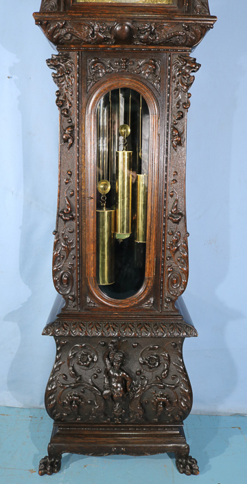 084b - Oak heavily carved 5 tube grandfather clock by R.J. Horner with Tiffany works, has carved figures and claw feet, 8 ft. 10 in. T, 27 in. W, 27 in. D.