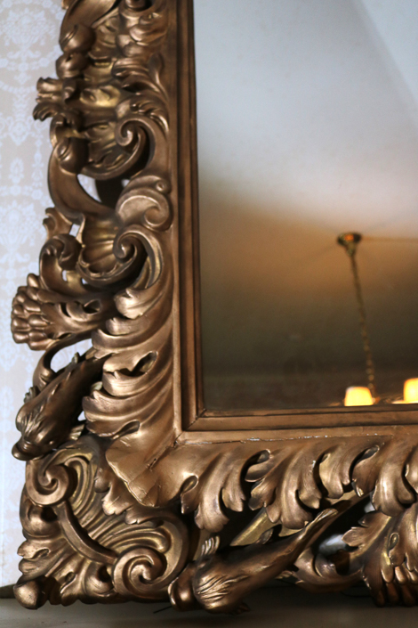 087d - Gold gilded over the mantle mirror with open pierced carving and dolphins, 48 in T, 68 in. L.