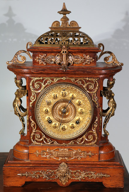 005a - Oak Victorian mantle clock by Ansonia with pendulum, 18 in. T, 12 in. W, 4.5 in. D.