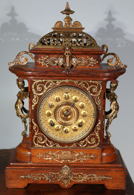 005c - Oak Victorian mantle clock by Ansonia with pendulum, 18 in. T, 12 in. W, 4.5 in. D.