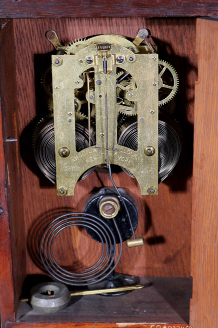 005d - Oak Victorian mantle clock by Ansonia with pendulum, 18 in. T, 12 in. W, 4.5 in. D.