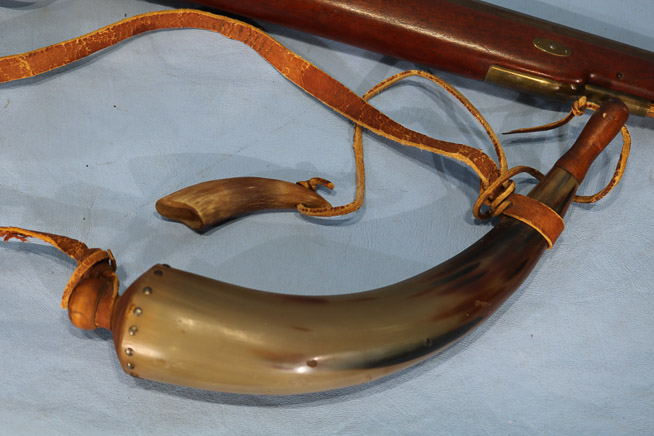 321a - Black powder muzzleloader with powder horn